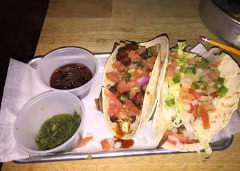 Tacos with toppings and sauce on the side